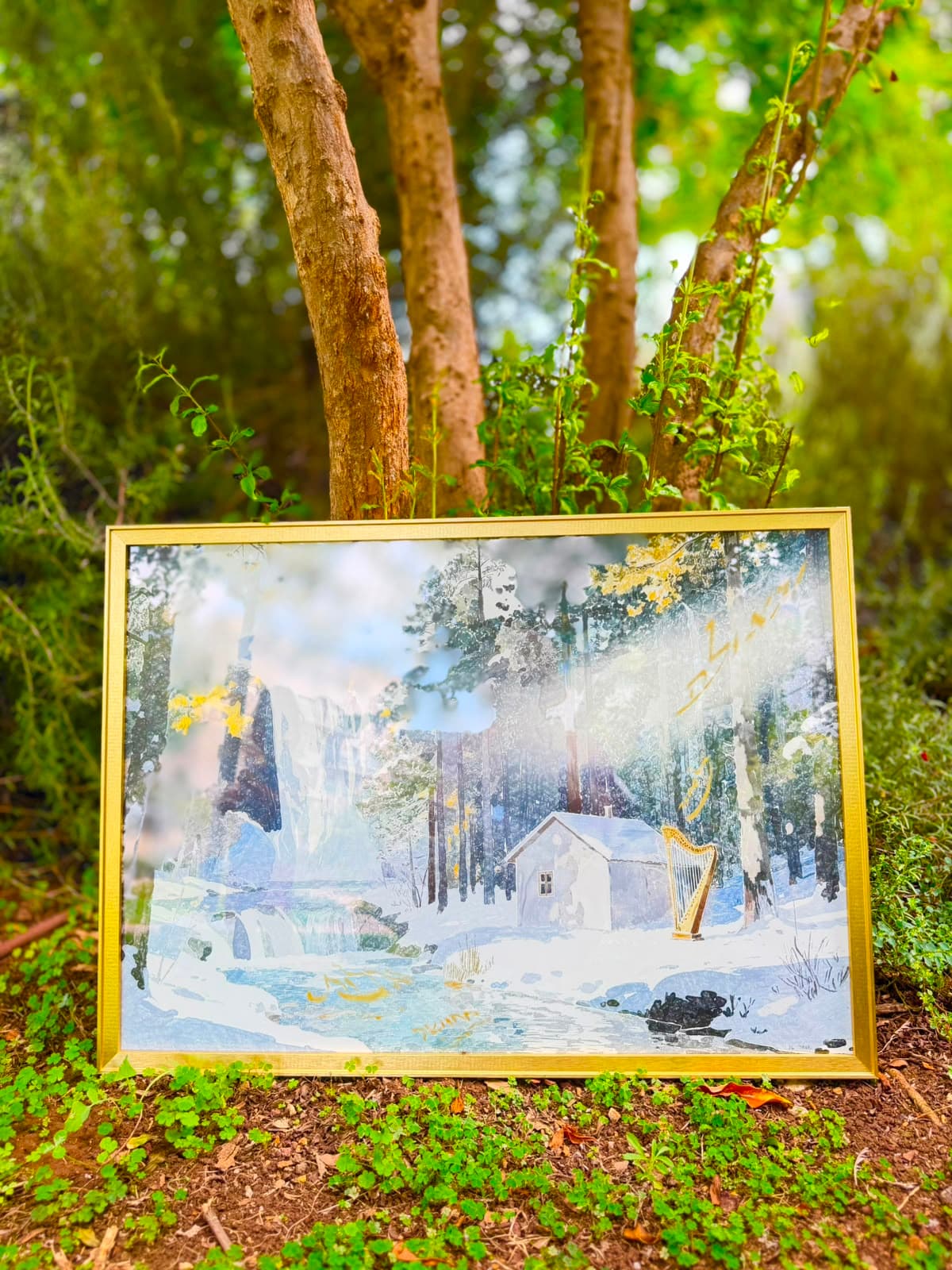 Shamil — framed gold artwork of a snowy forest, cabin, and harp