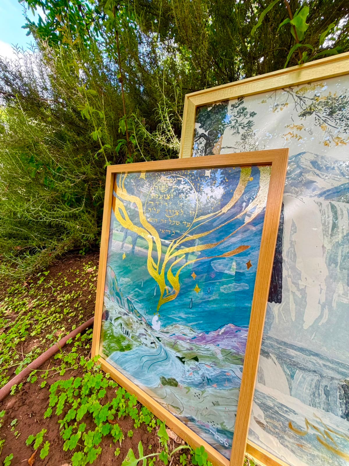 The Soul Descends framed artwork angled in a garden